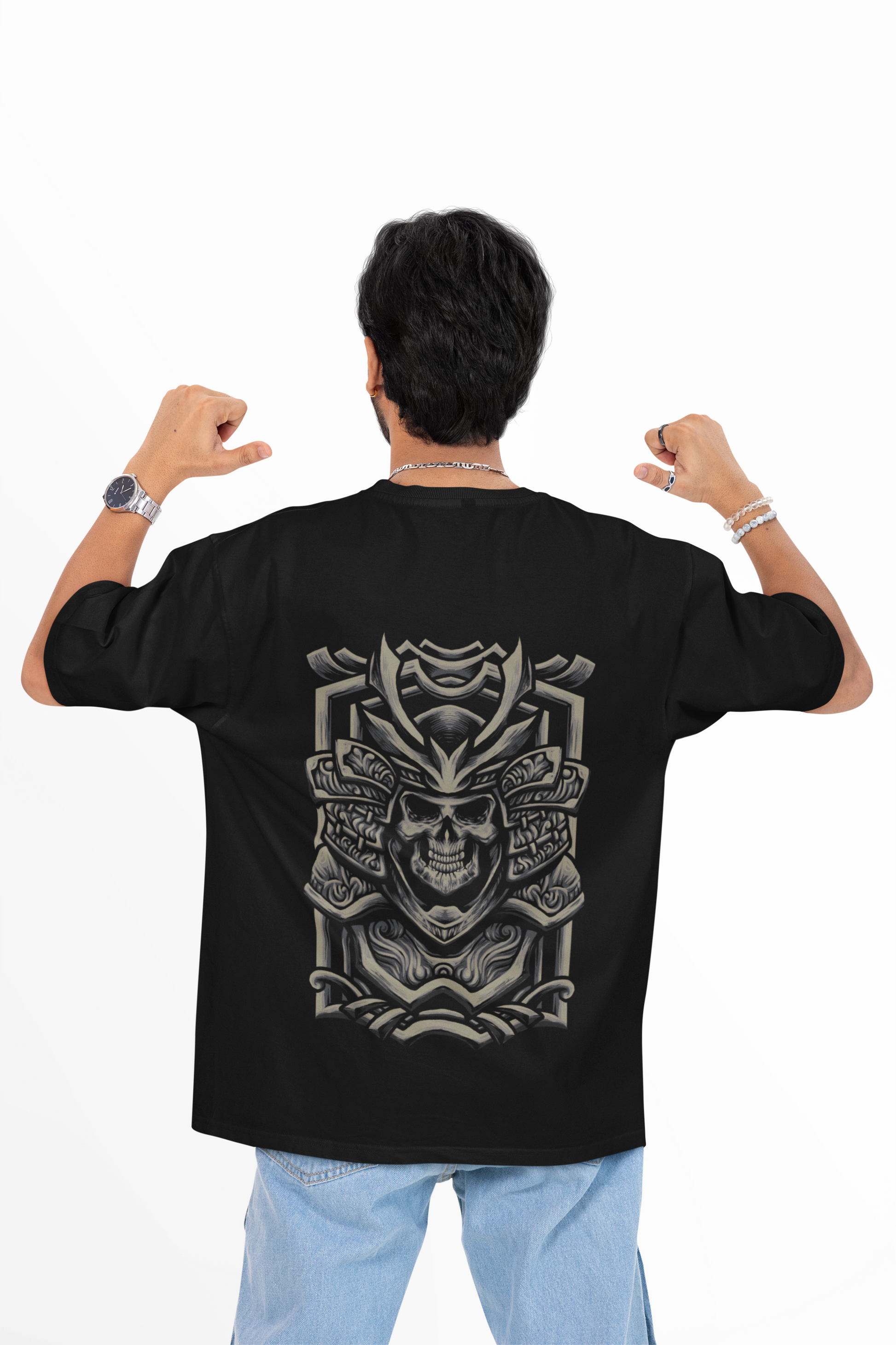 Person wearing a black t-shirt with a skull design on the back, standing against a white background